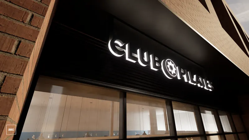 Junction Triangle studio — illuminated brand lettering above the glazed storefront.