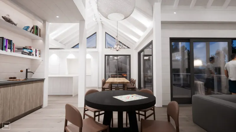 Games table and timber dining table below white-painted rafters and high glazing.
