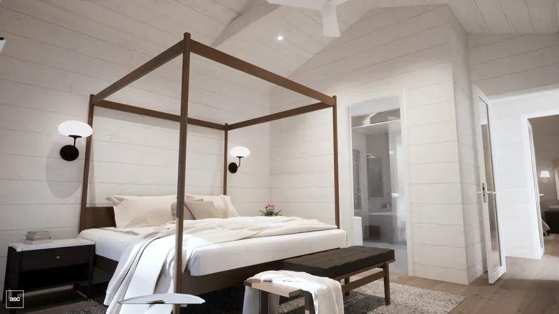 Timber four-poster bed against white-panelled walls beside openings to the ensuite and hall.