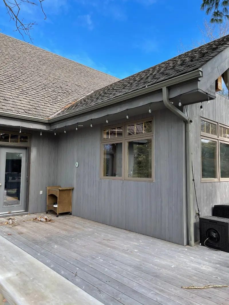 Existing timber-clad walls and windows facing the deck.