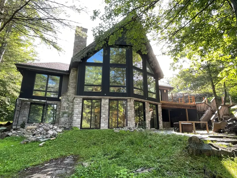 Glazed gable above the stone base and garden.