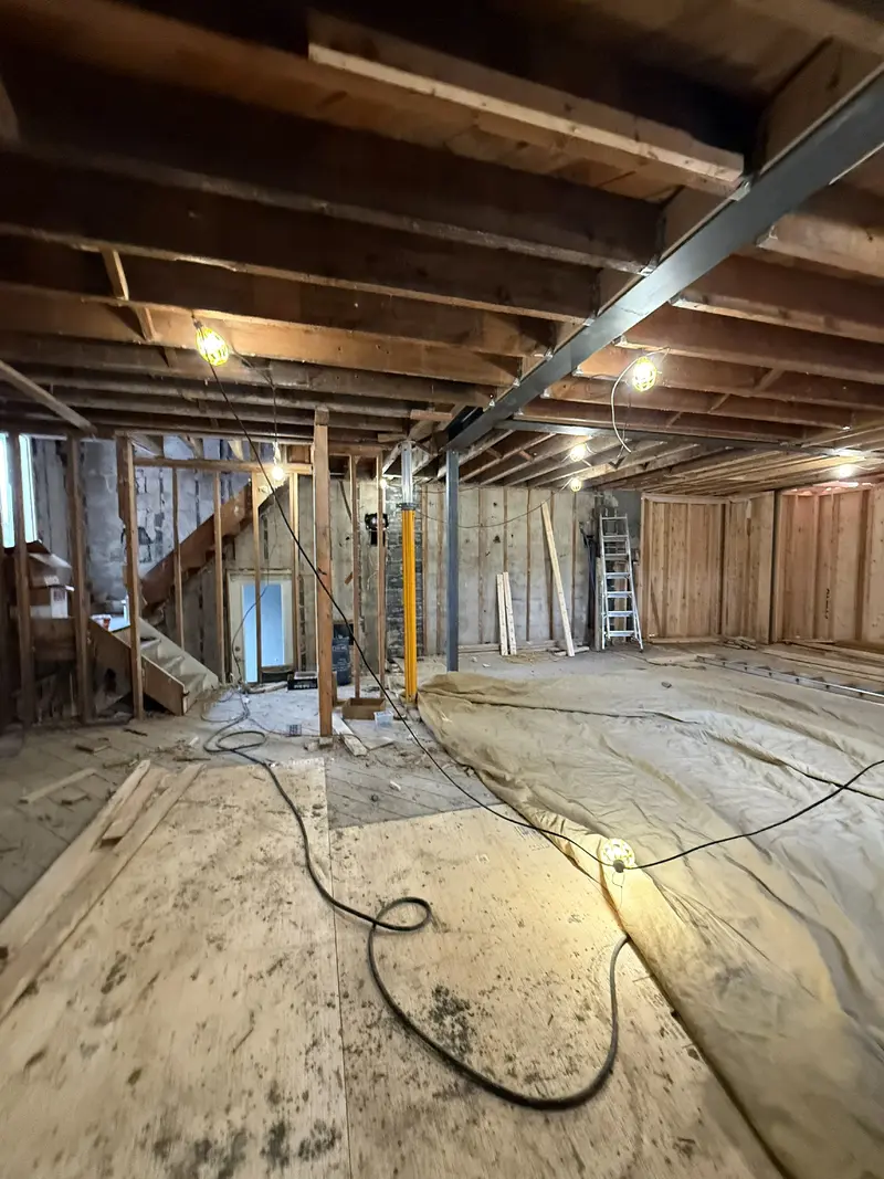 Steel beam and exposed joists during structural work.