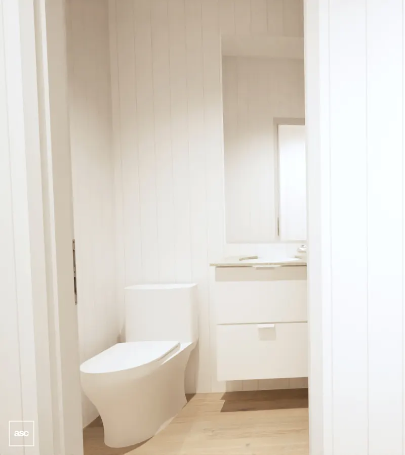 Compact white bathroom with a floor-standing toilet and wall-hung vanity.