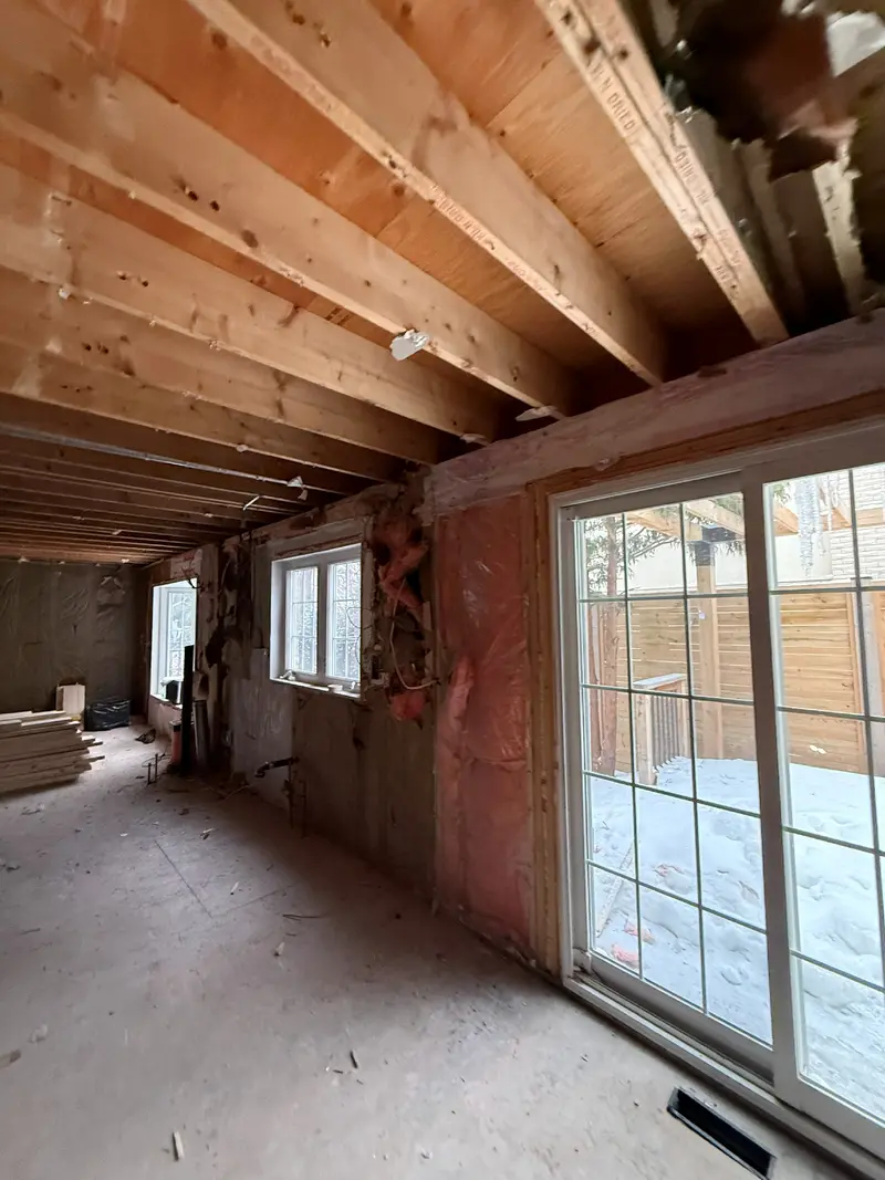 Exposed floor joists above the stripped interior.