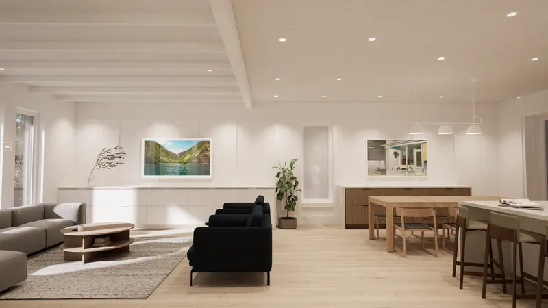 Pale oak dining table and white kitchen island opening onto a bright sitting room.