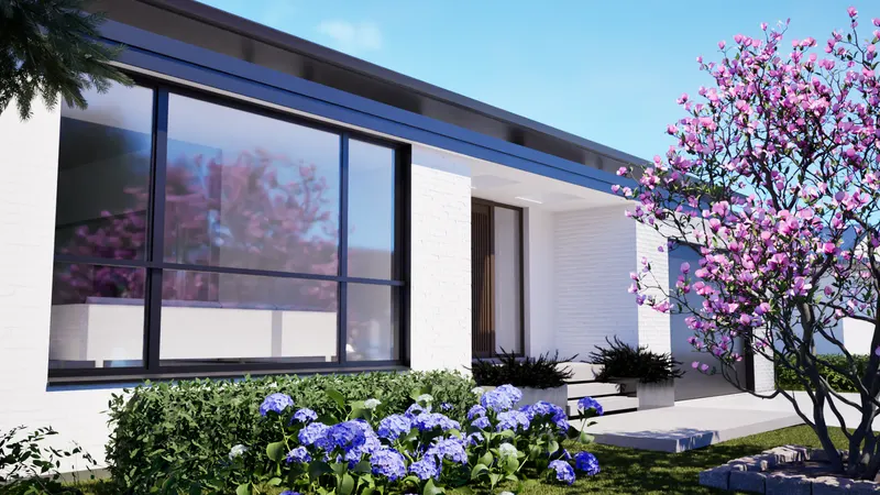 Tall corner glazing beside white walls, dark roof edges and flowering planting.