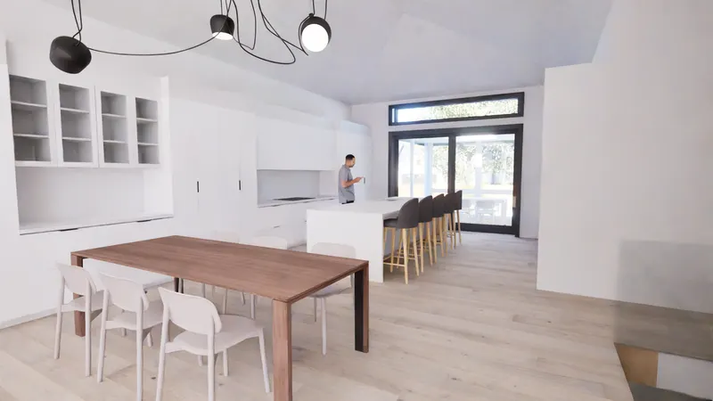 Timber dining table and white kitchen island below a sculptural black pendant.