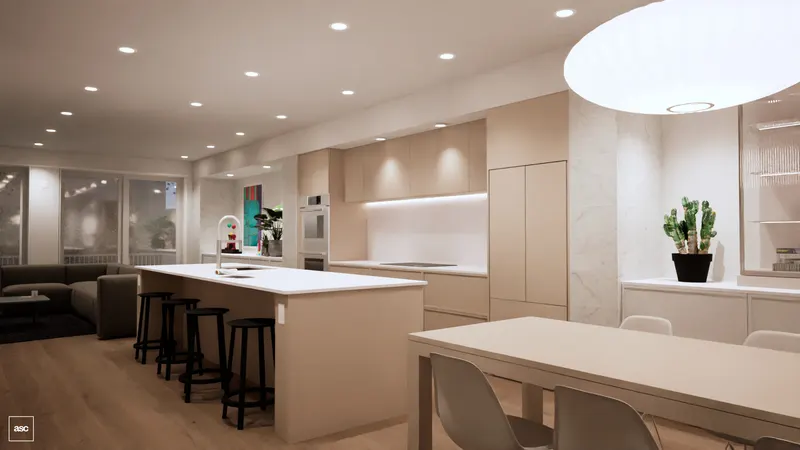 Pale dining table beneath one oval pendant beside an island with a white top and pale beige base.
