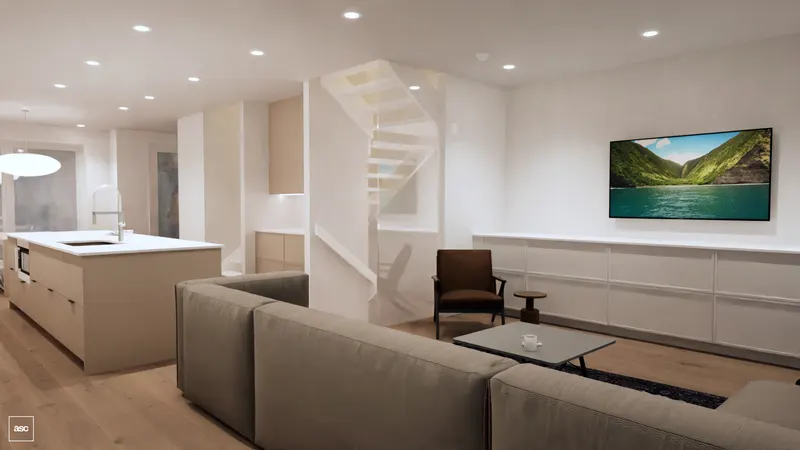 Grey corner sofa facing a low media cabinet beside a glass stair balustrade.