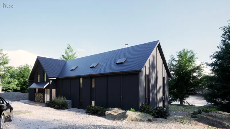 Gravel approach beside a long black wall and standing-seam roof.