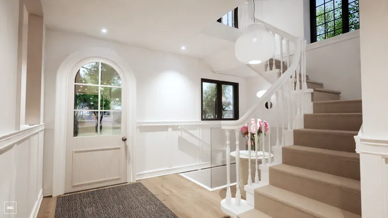 Arched glazed front door beside a curved white stair with carpeted treads.
