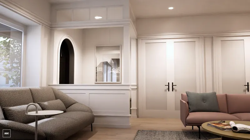 Grey and pink sofas against white-panelled walls and an arched doorway.