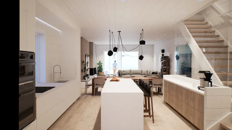 Long white kitchen island beside an open stair with a glass balustrade.